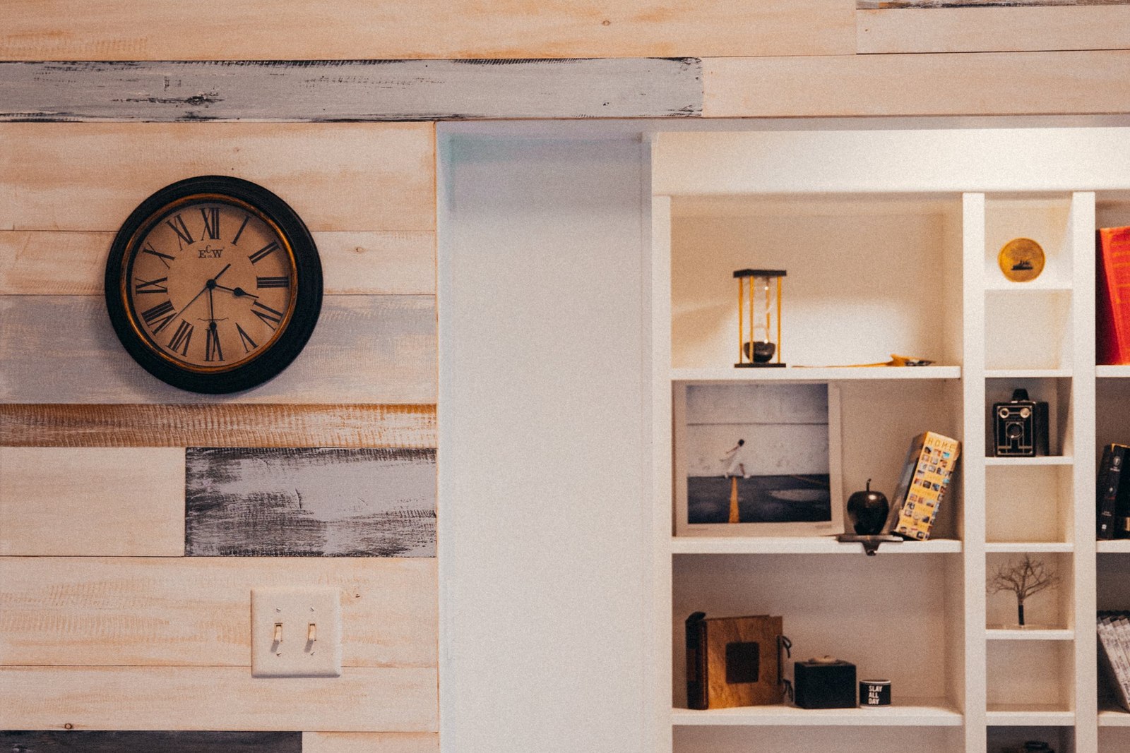 Timber wall lining meeting an open white storage unit