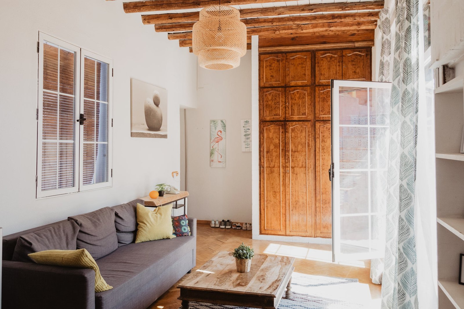 Sunlight entering a living room through open wooden doors