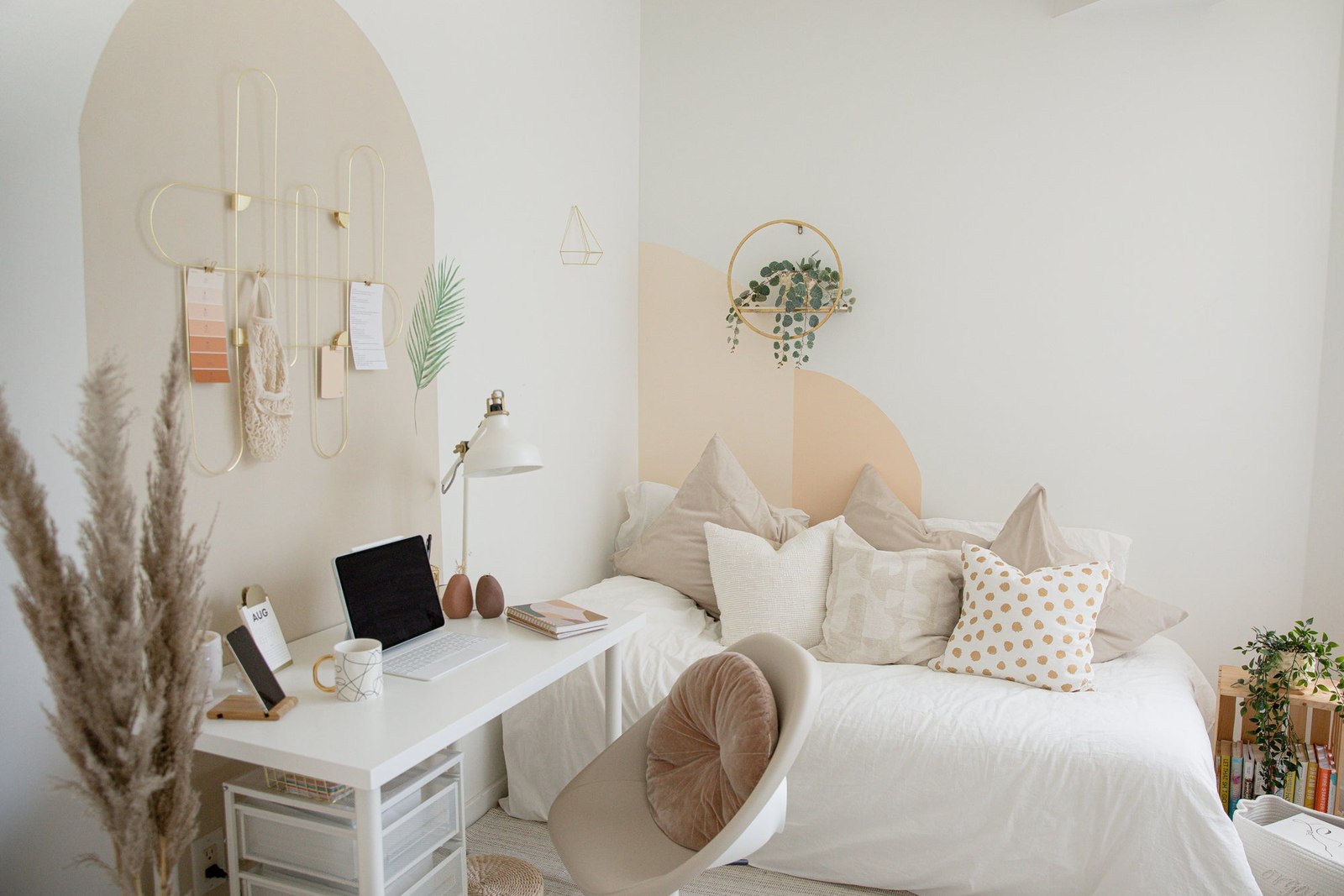 White desk and soft corner seating in a light compact room