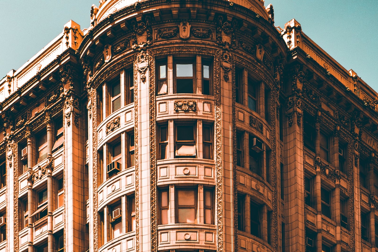 Sunlit corner of an ornate brick and stone building